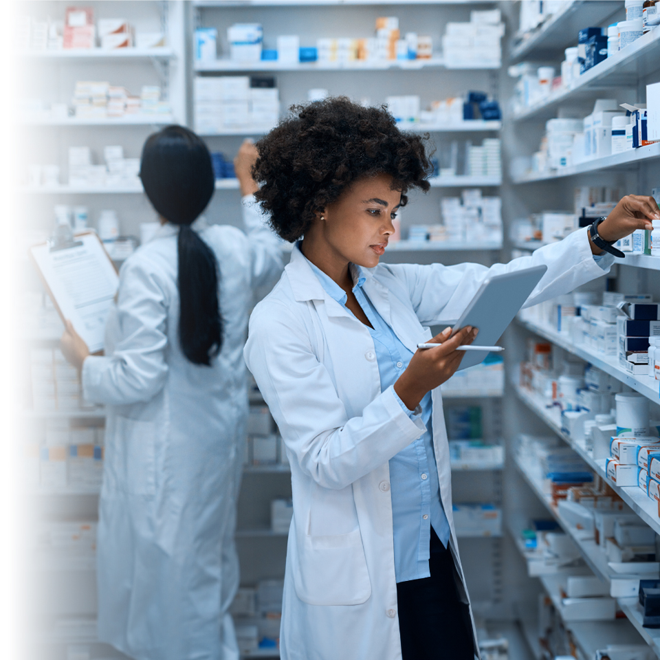Two female pharmacists working to fill prescriptions in a pharmacy.