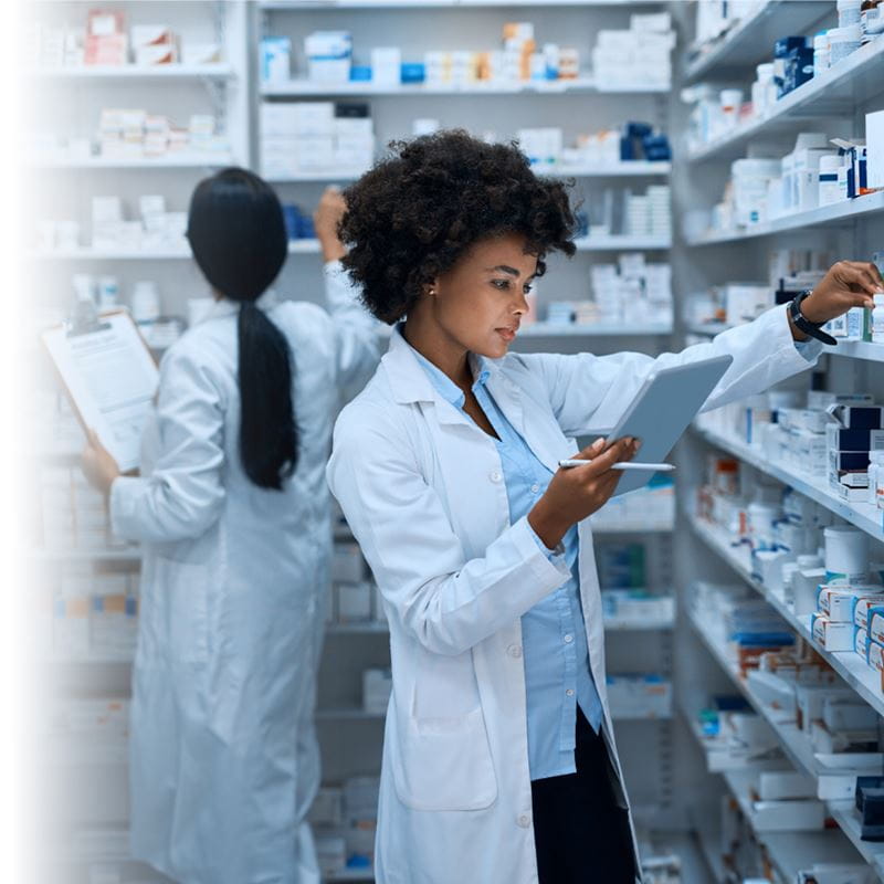 Two female pharmacists working to fill prescriptions in a pharmacy.